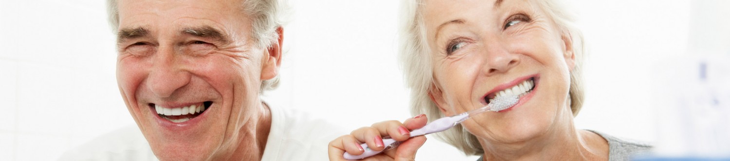 Happy Laughing Seniors Brushing Their Teeth